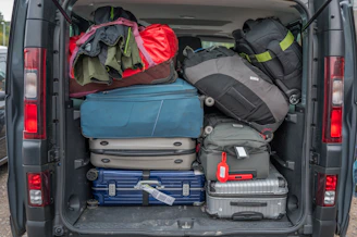 Van packed full with luggage for a trip.