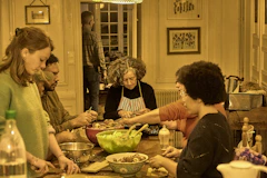 People gathered around a table preparing food together
