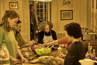 People gathered around a table preparing food together