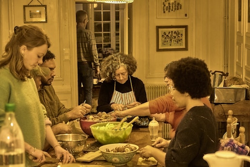 People gathered around a table preparing food together