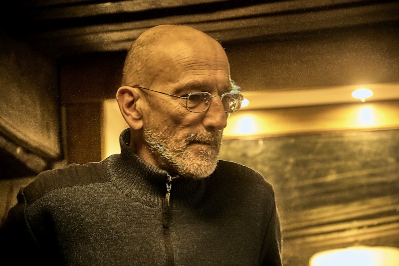 Mature man with glasses and beard indoors