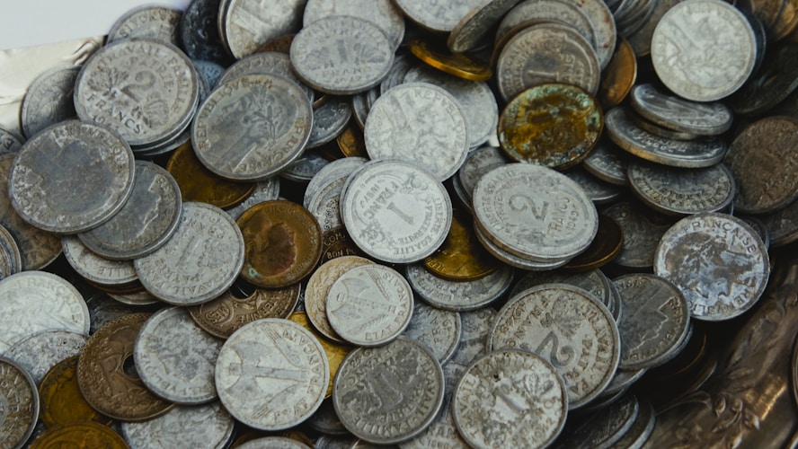 Pile of old tarnished coins illustrating the variety of gold products available to investors