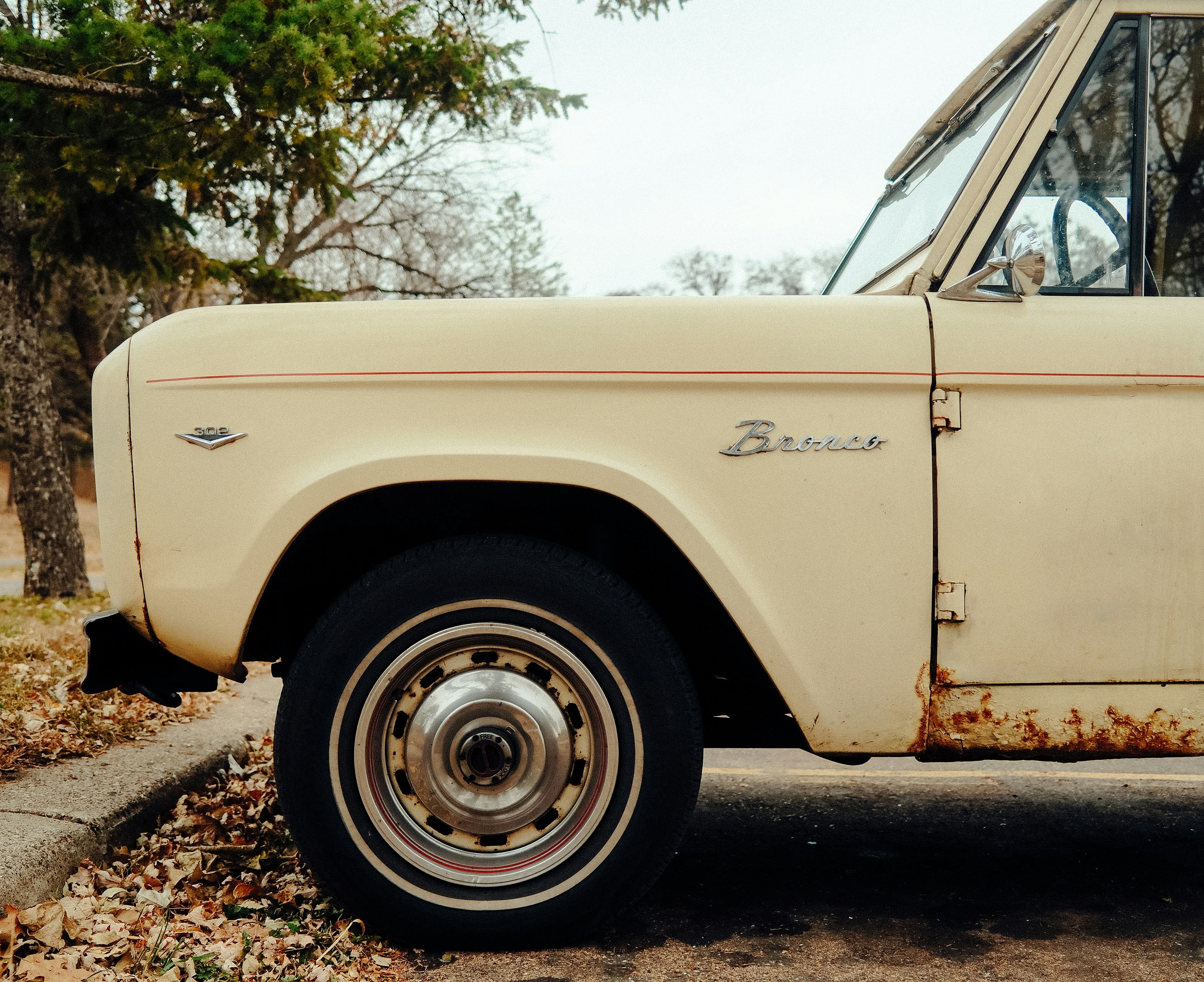 Cream colored vintage bronco parked outdoors