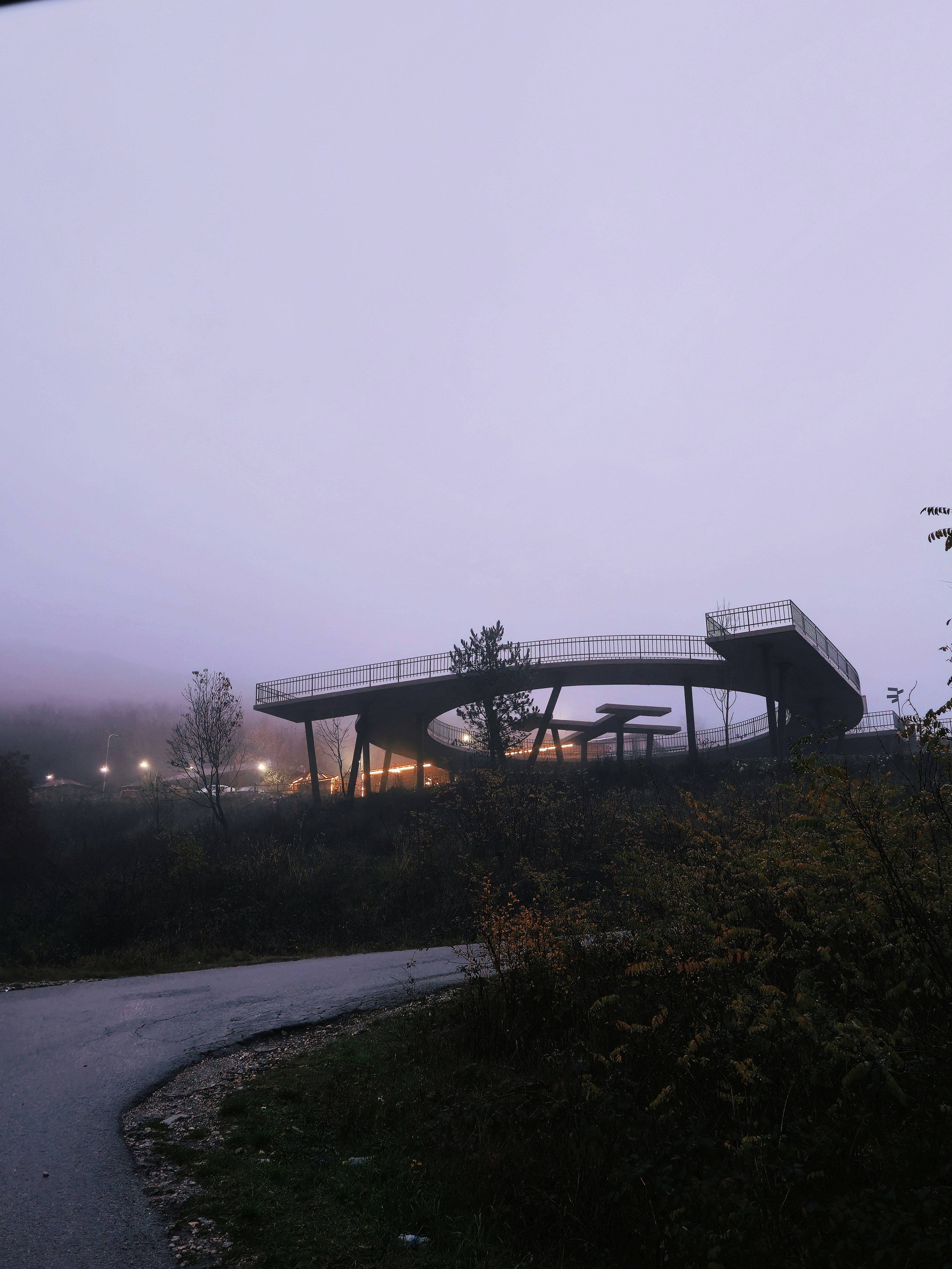 Modern elevated walkway in foggy landscape