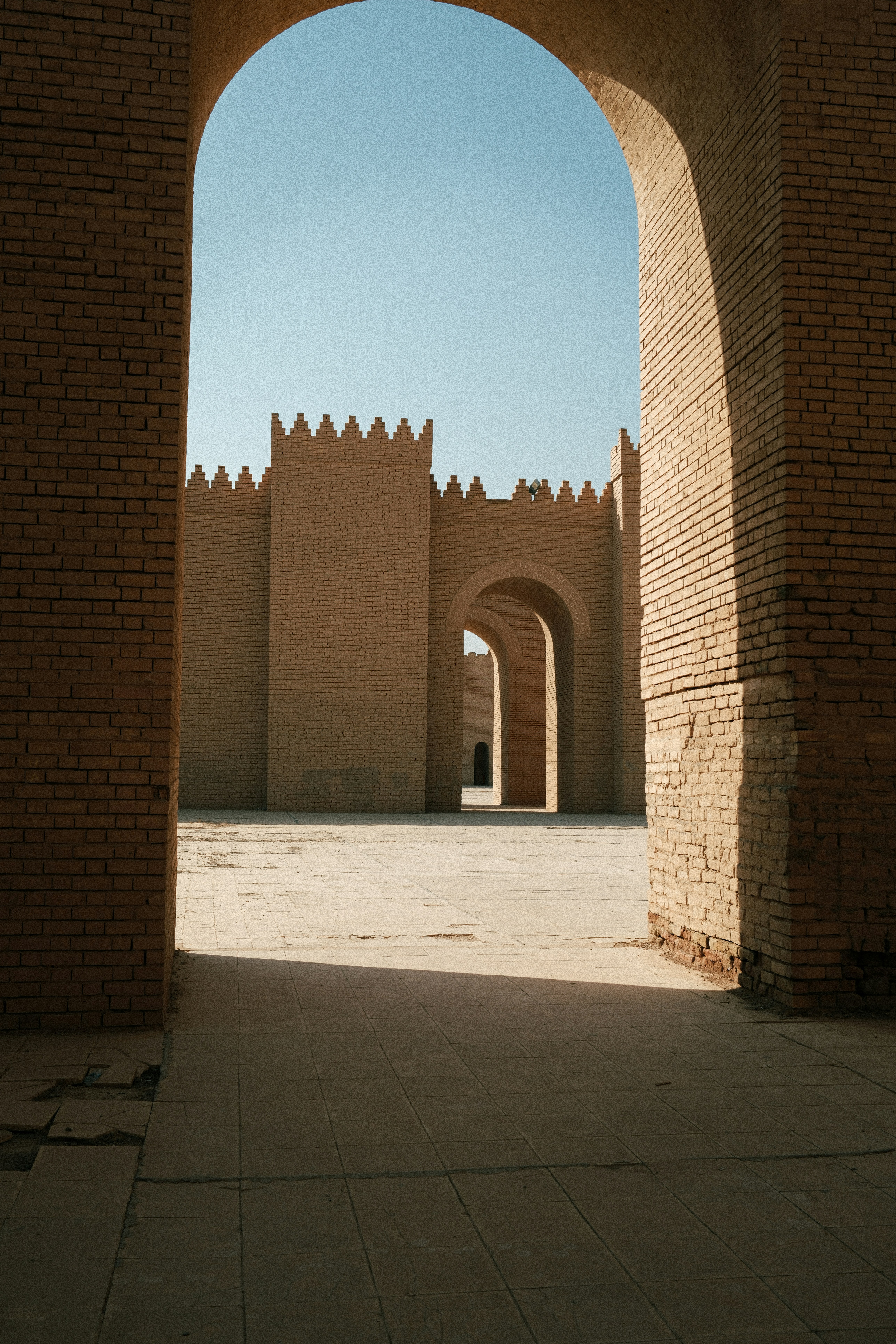 Ancient brick gateway with crenellated walls and arched walls.