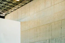 Concrete wall with industrial ceiling structure above