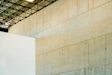 Concrete wall with industrial ceiling structure above