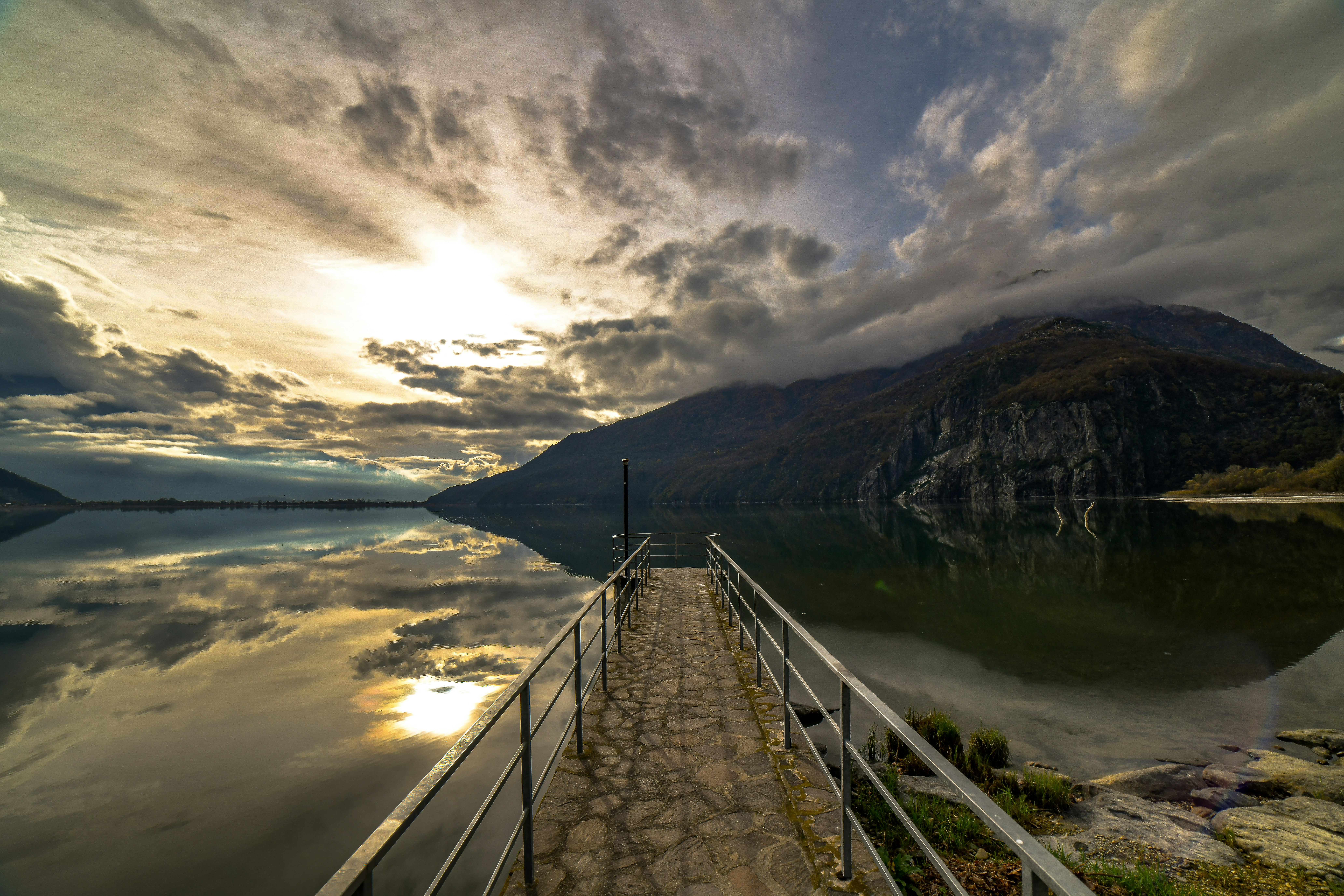 Wooden pier on a lake with a mountain backdrop.