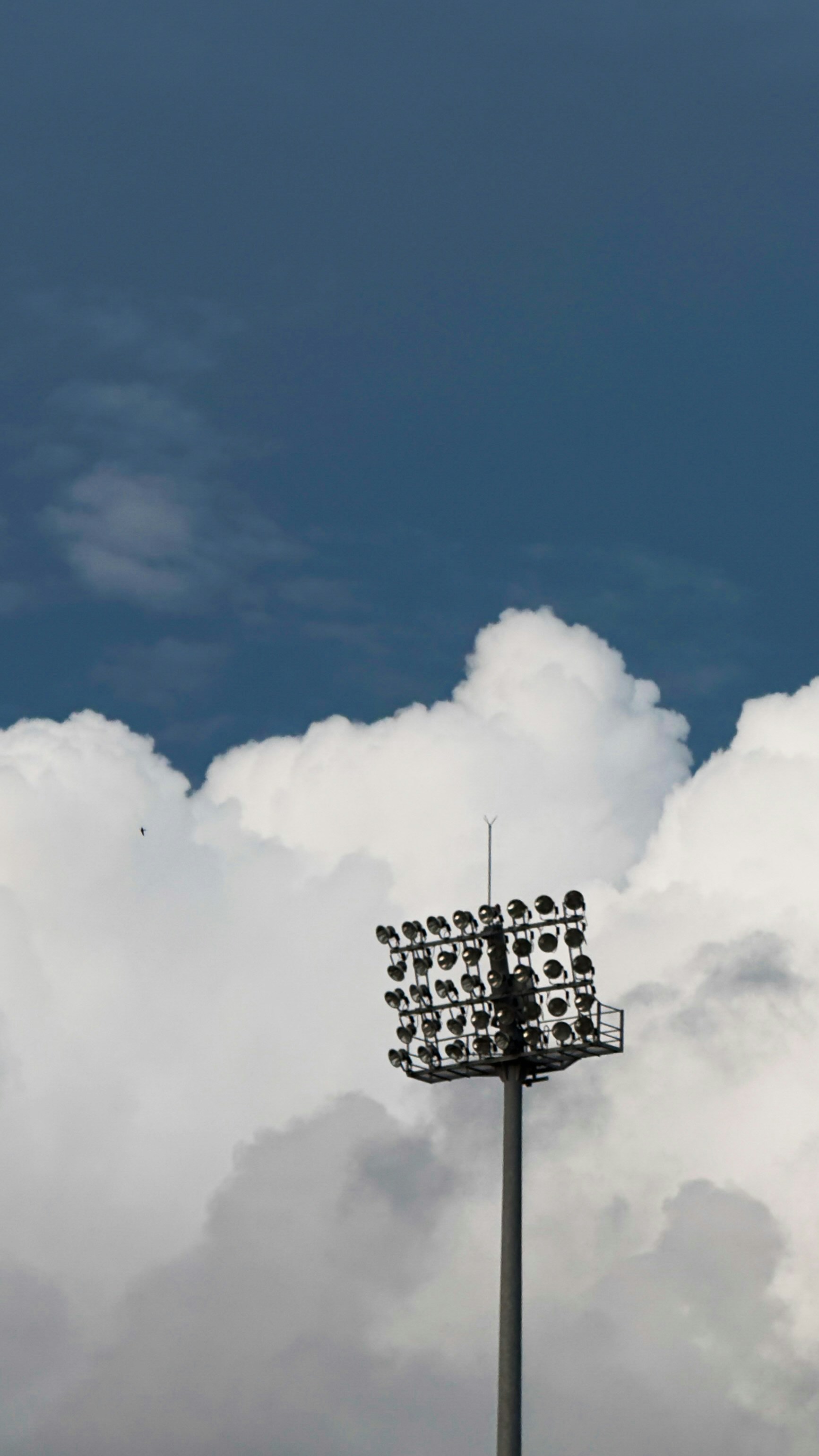Stadium floodlight against a cloudy sky