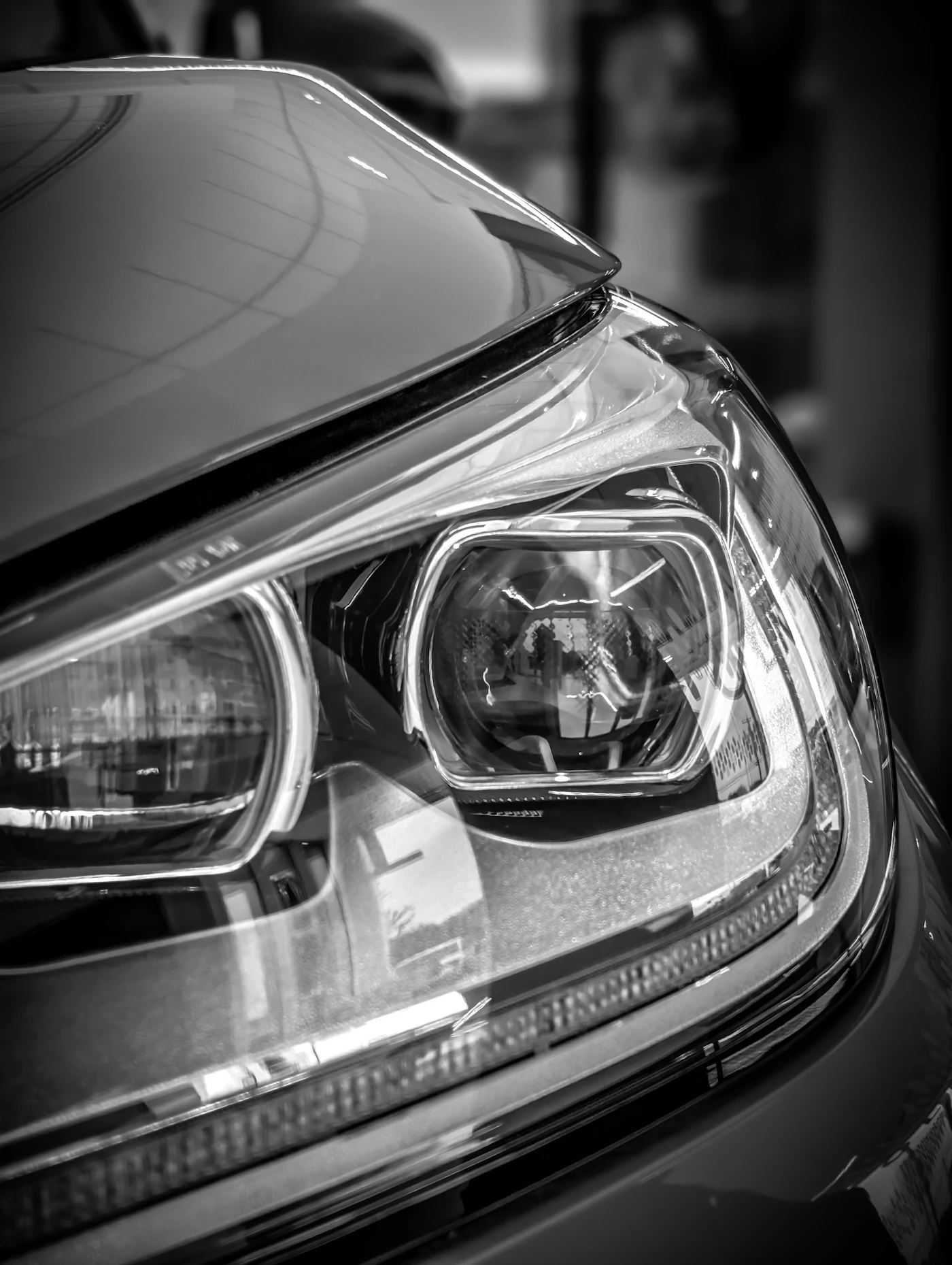 Close-up of a modern car headlight at night
