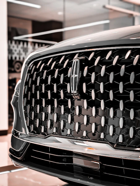 Close-up of a modern car grille with emblem.
