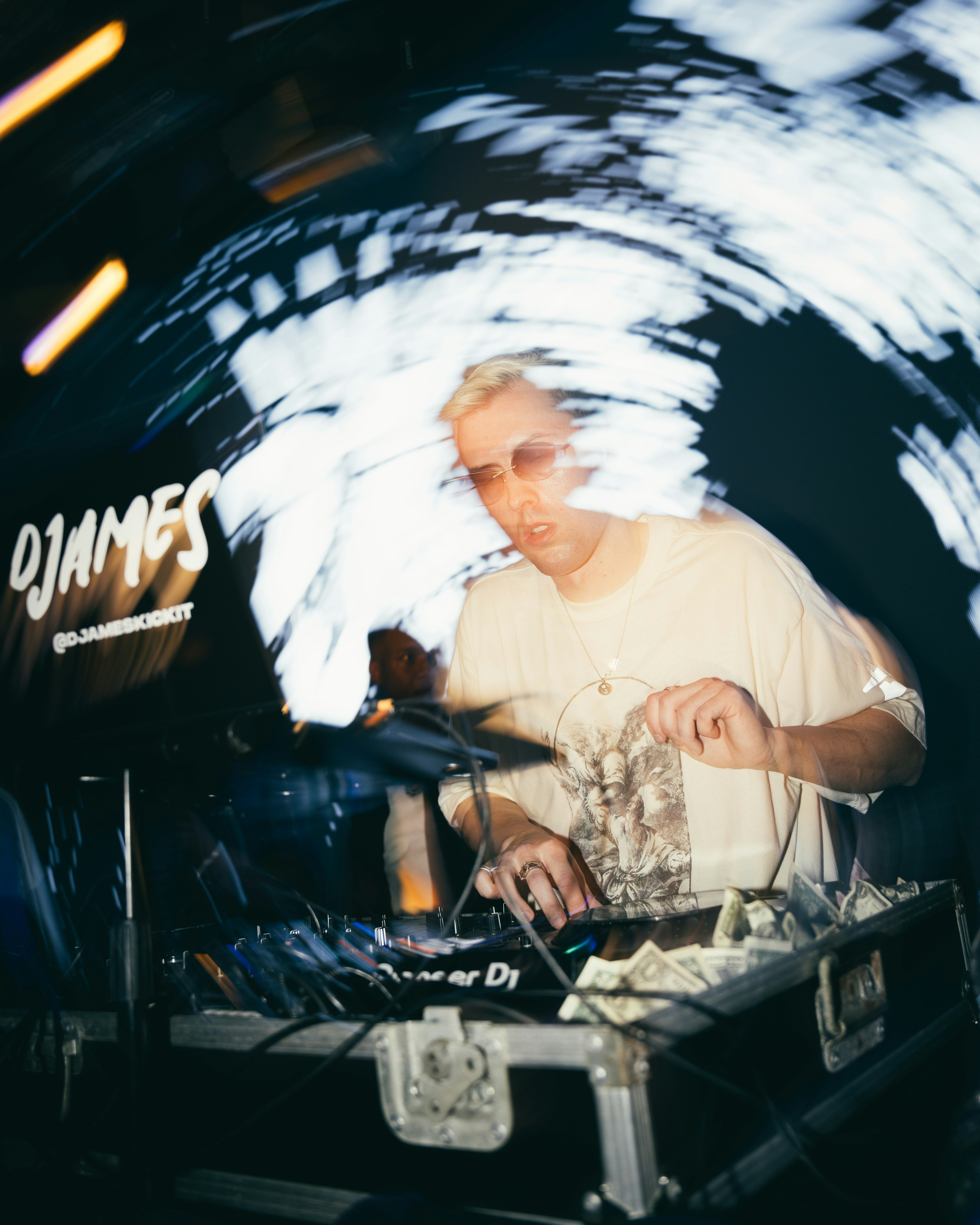 Dj playing music with blurred lights