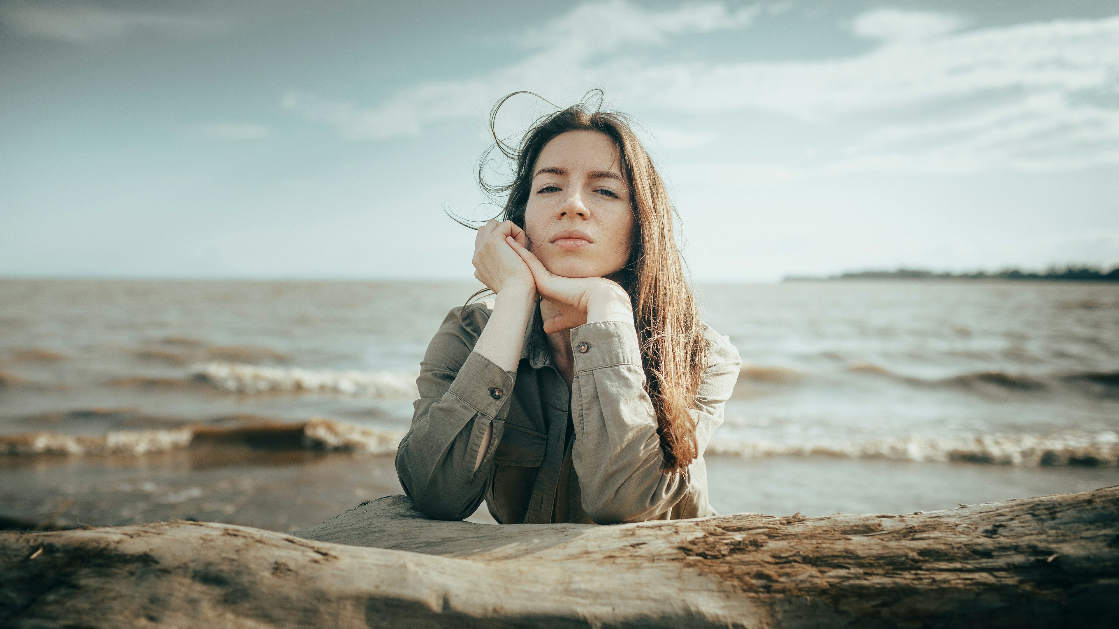 Young woman resting by the sea