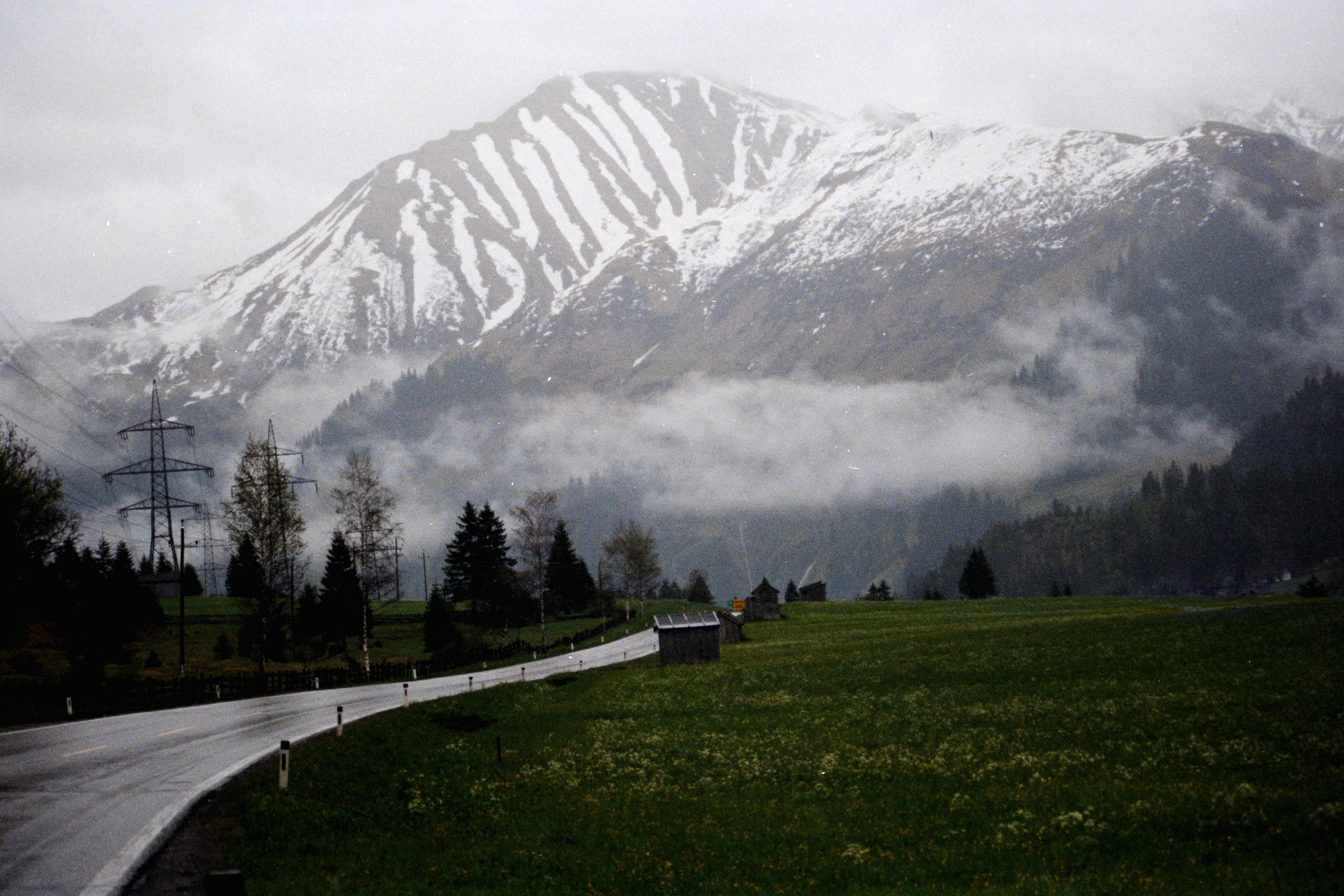 Snow-capped mountain peaks shrouded in mist