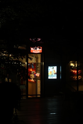 Restaurant entrance at night with glowing signs
