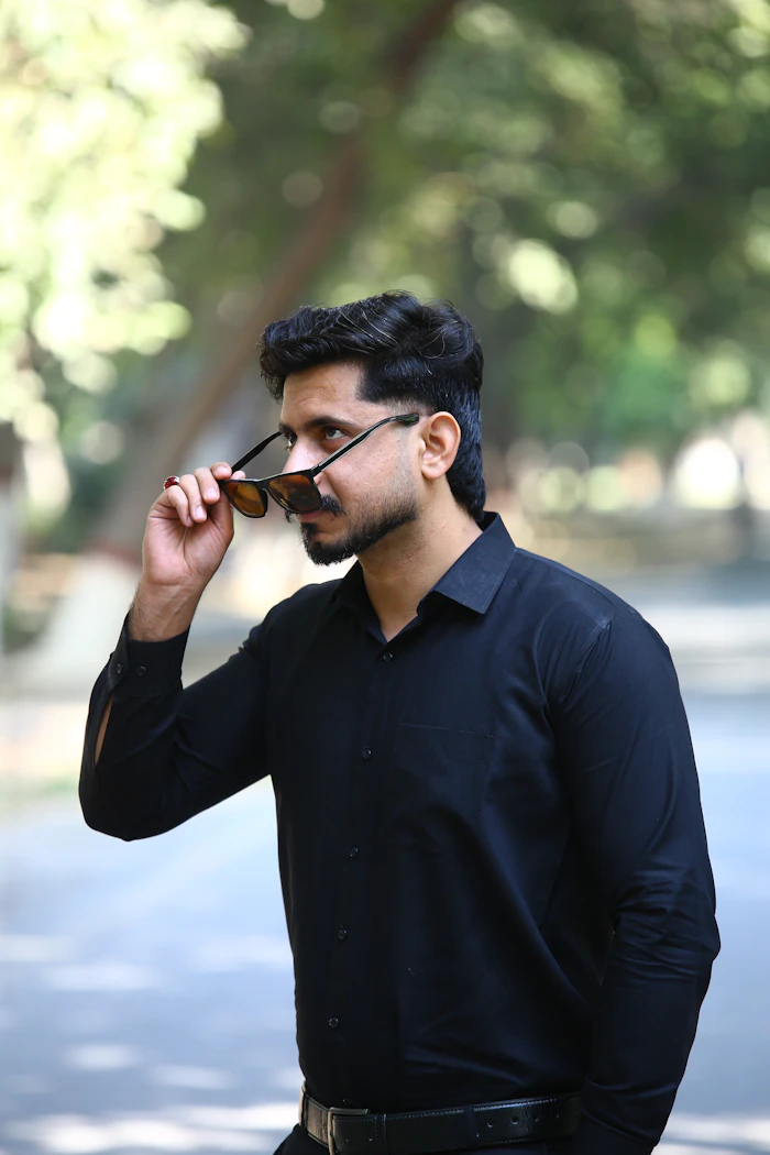 Customer in black shirt adjusting sunglasses