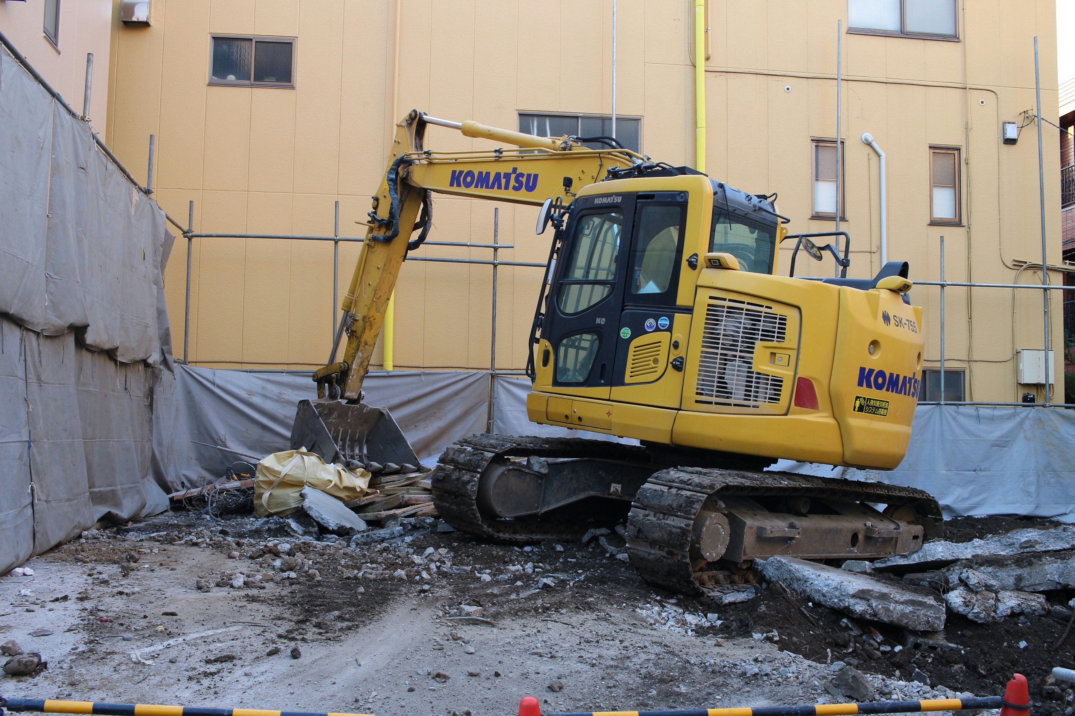 A yellow excavator at a construction site in Quebec
