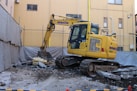 Yellow excavator on a construction site.