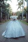 Young woman in a ball gown holding flowers