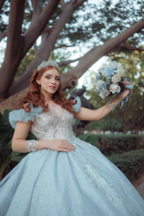 Woman in a blue gown holding a bouquet