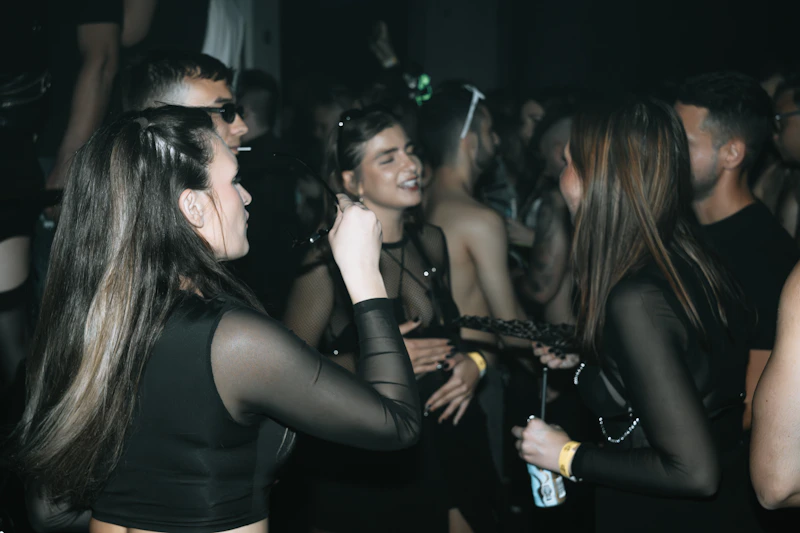 young people socializing in a dark club