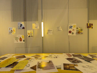 Children's artwork displayed on a wall above a table.