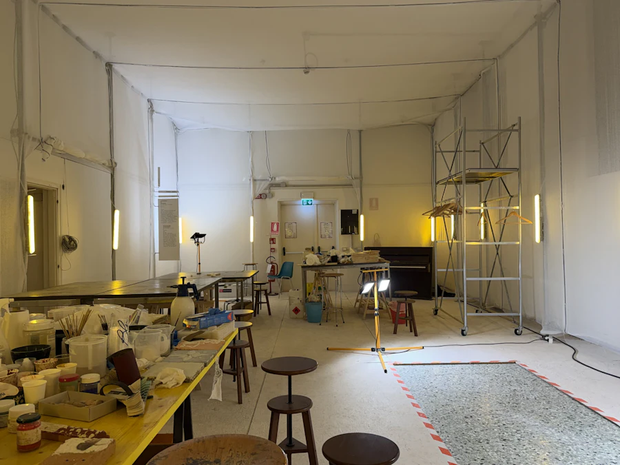 An artist studio with materials and lighting equipment
