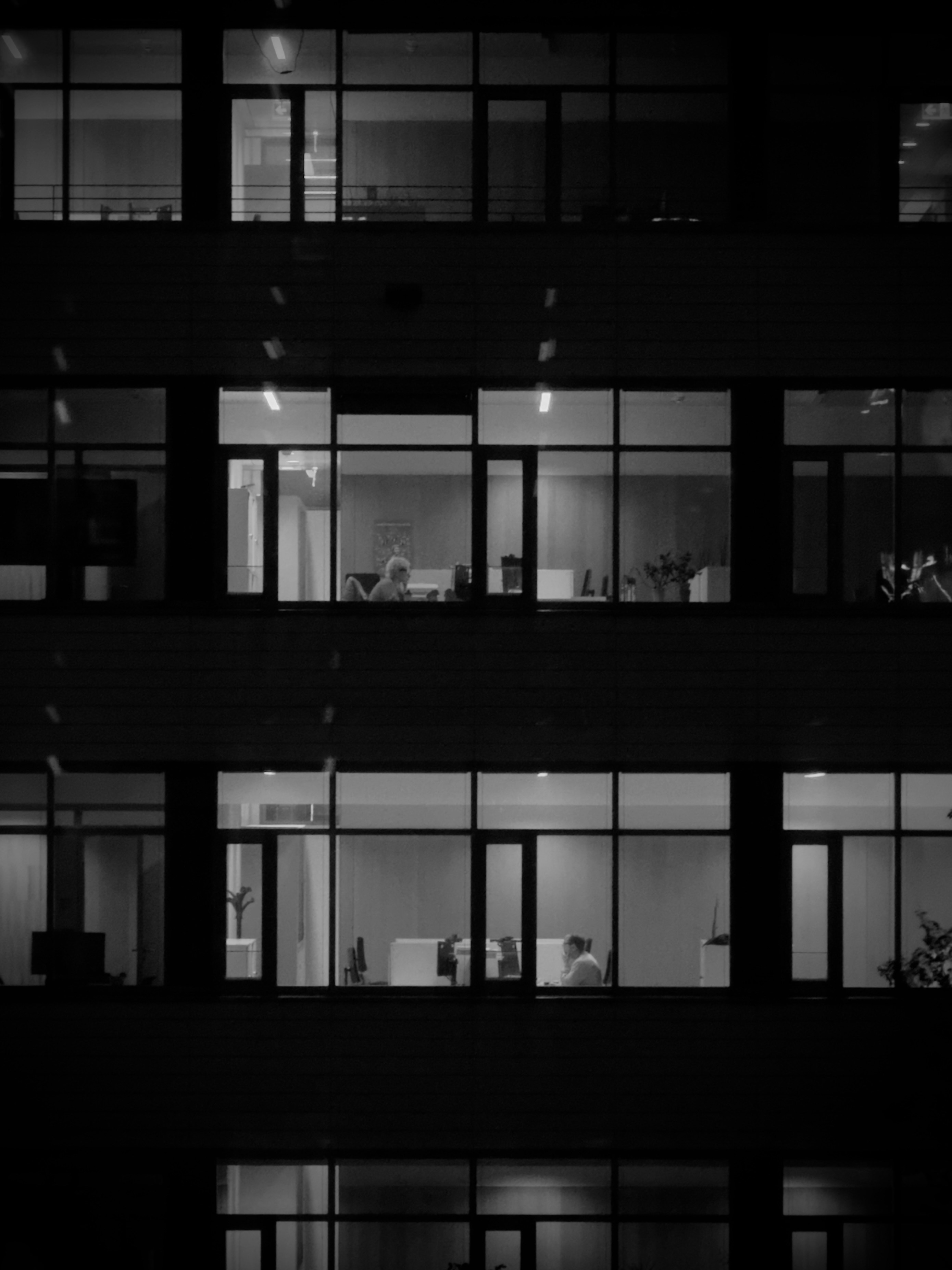 Office building windows at night with people inside