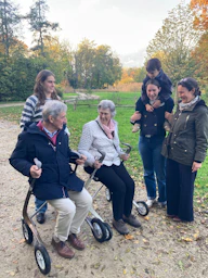 Family gathers in a park during autumn