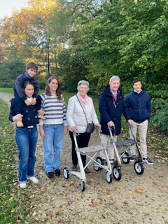 A multi-generational family walking in a park.