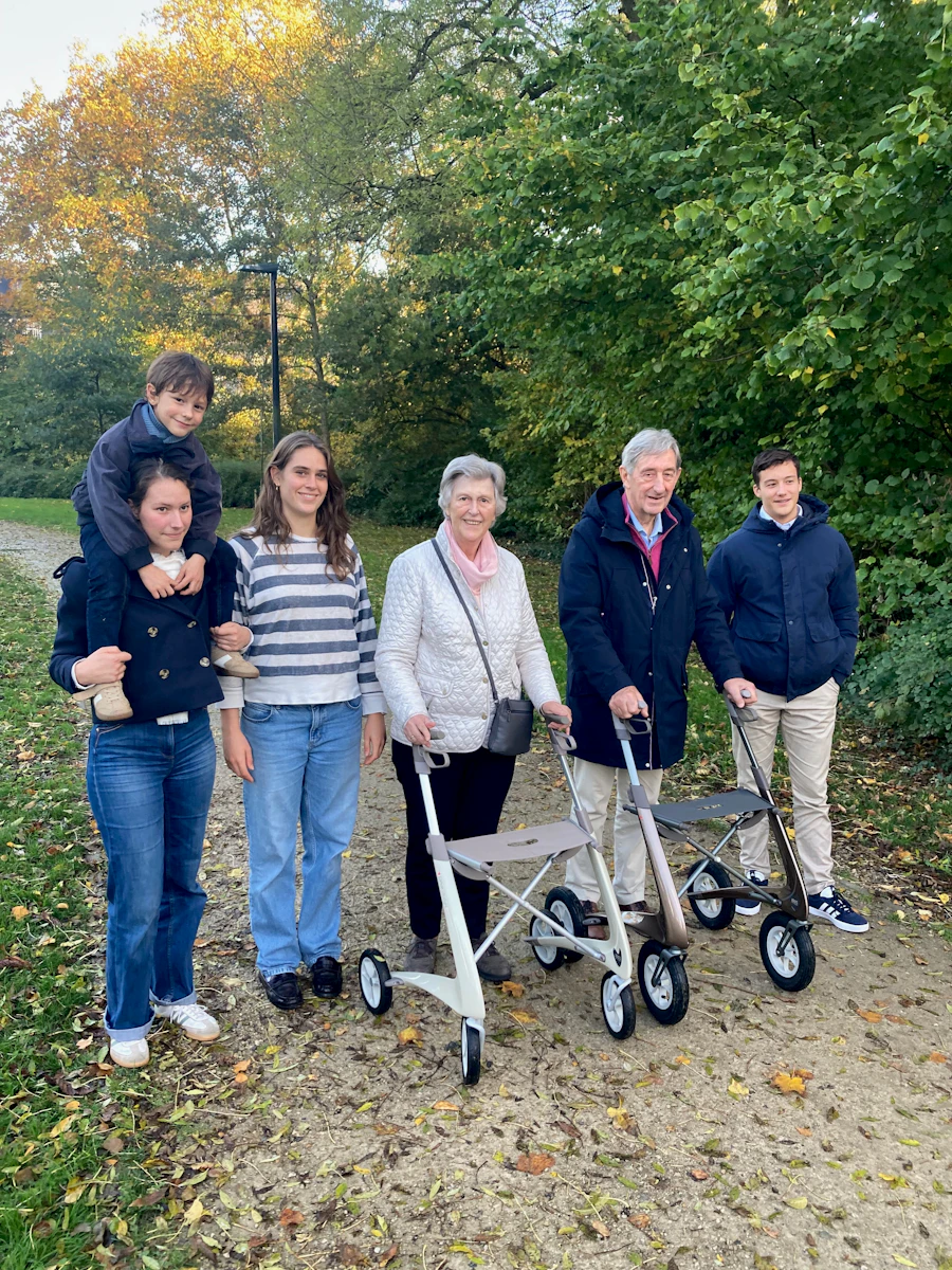 A multi-generational family walking together outdoors