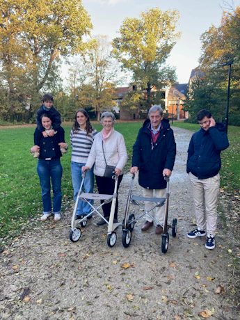 Family posing with walkers in an autumn park