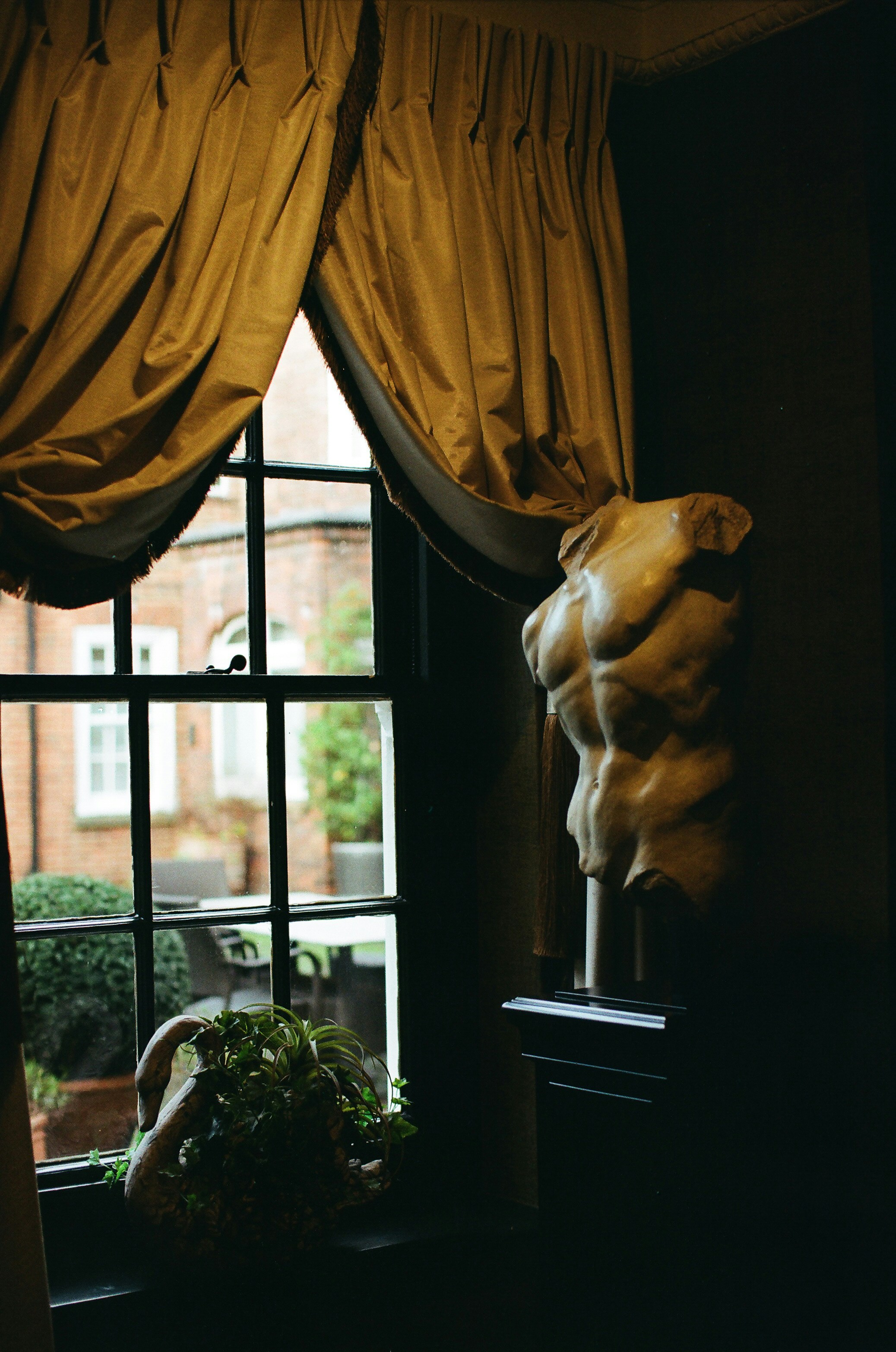 Marble torso sculpture beside a window with curtains photo – Free ...
