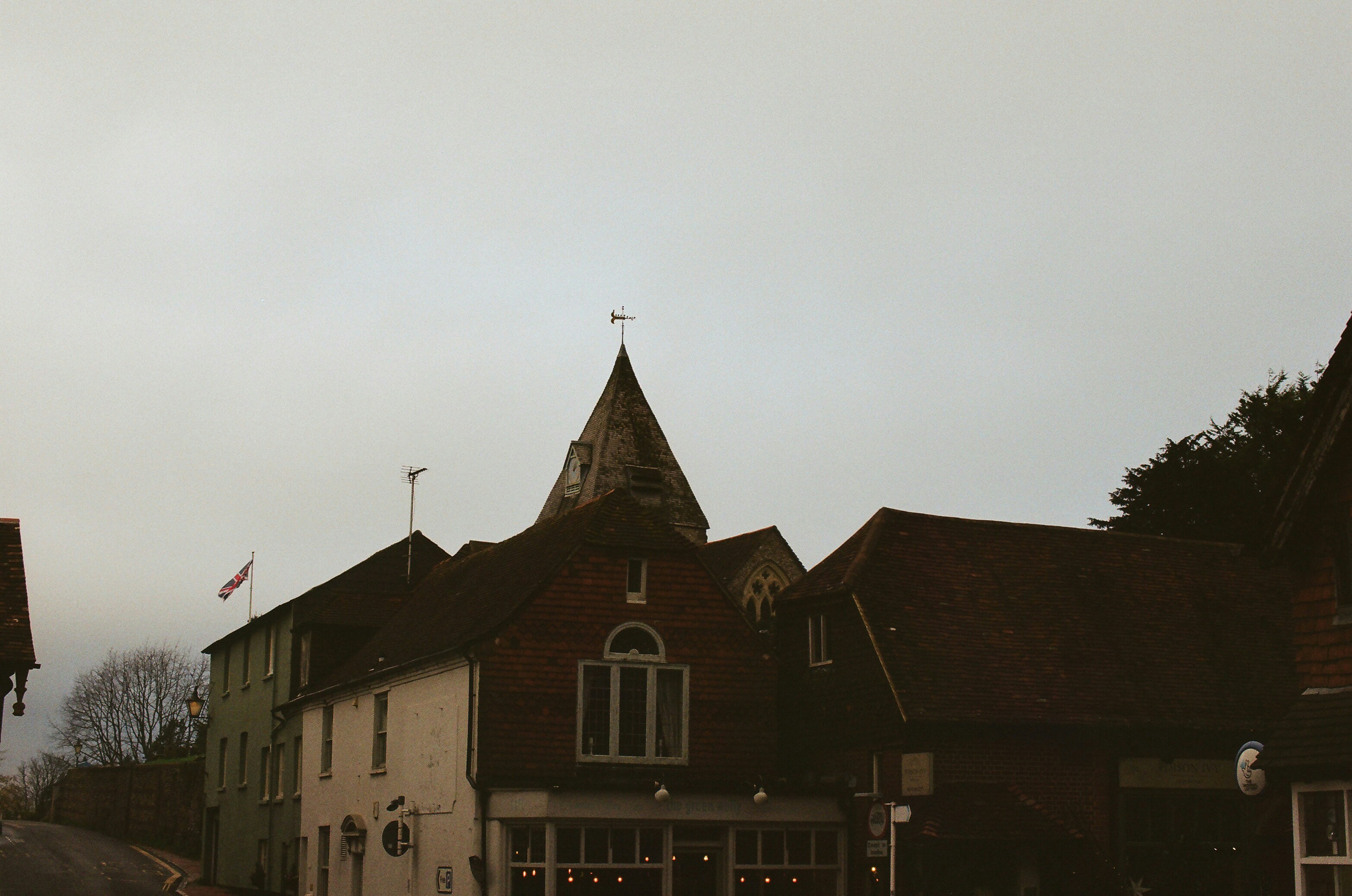Historic building with a conical roof and weather vane. photo – Free ...
