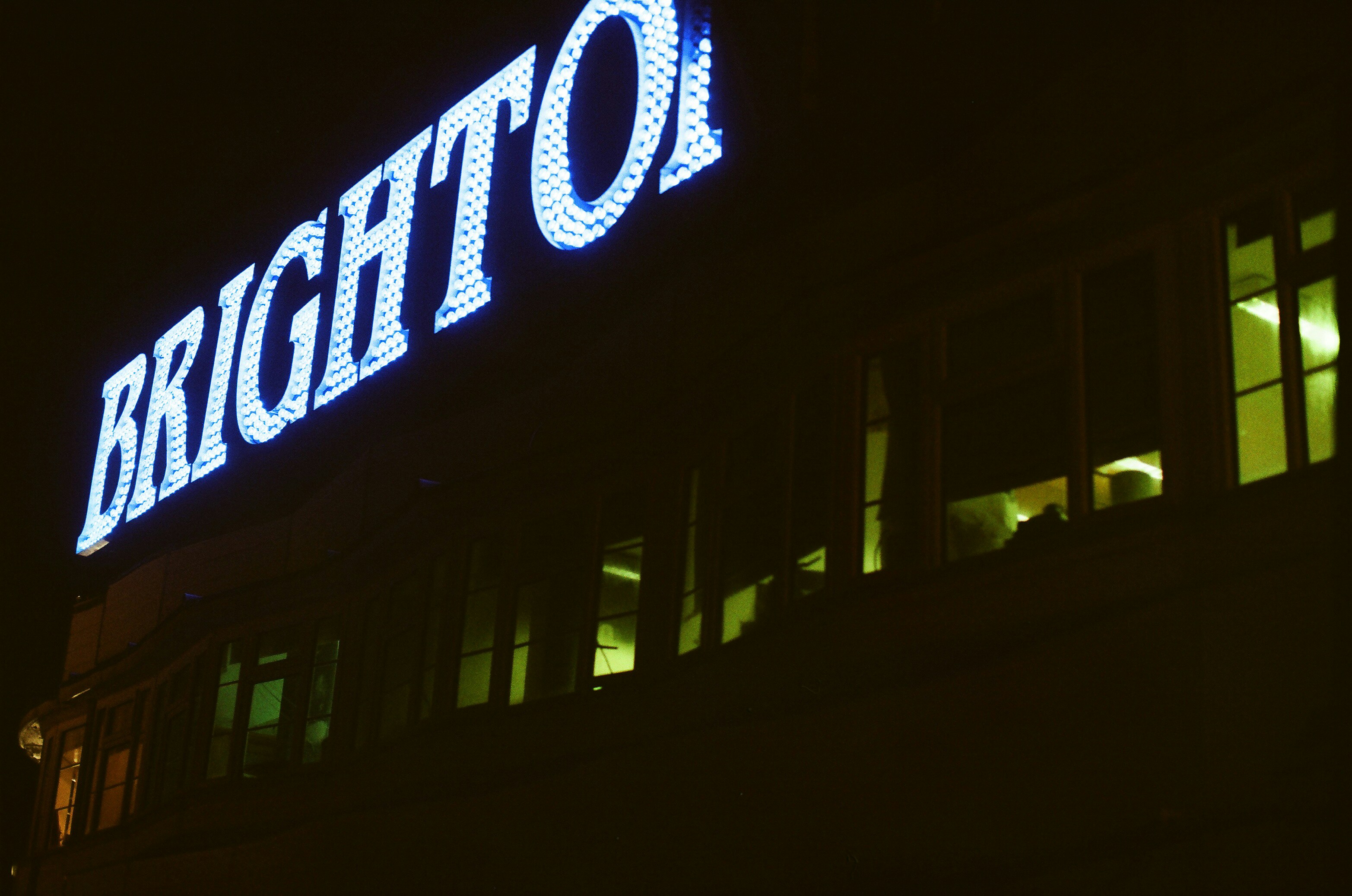 Brighton sign illuminated at night on building