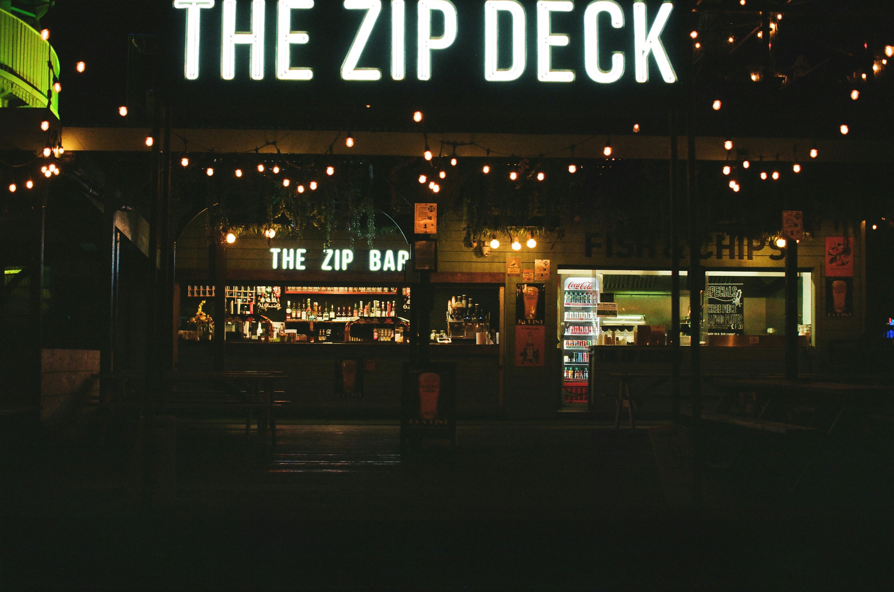 The zip deck bar at night with string lights