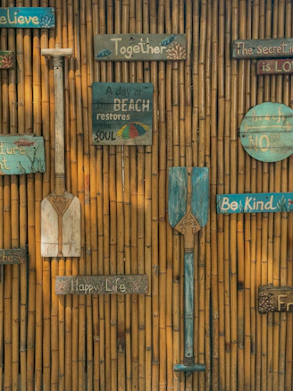 Decorative paddles and signs on bamboo wall