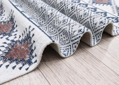 Close-up of a textured rug with geometric patterns Kanha Universal Export