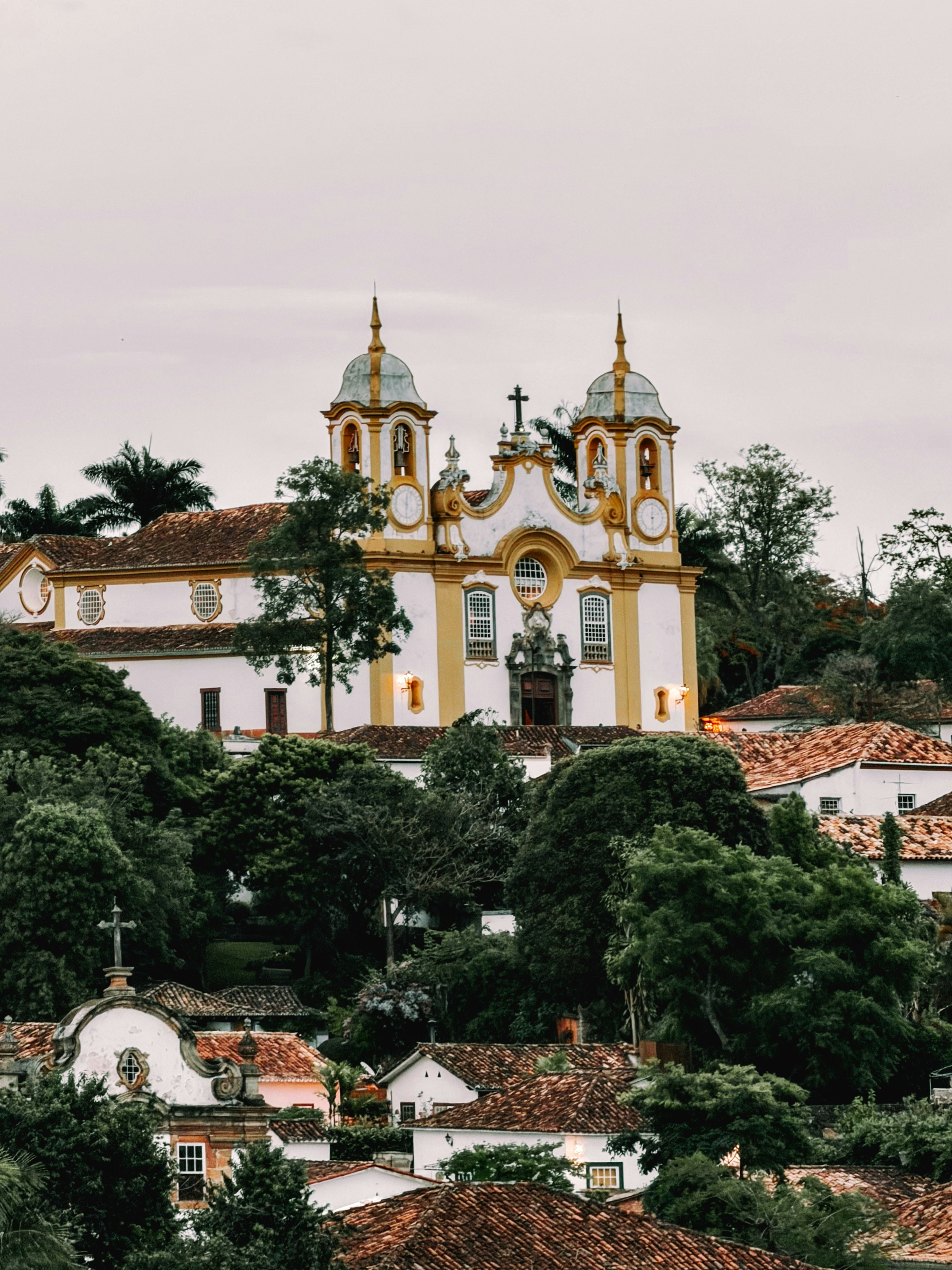 Historic church with yellow accents on a hill