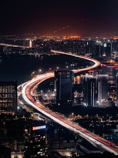 Vibrant cityscape with light trails on highway at night