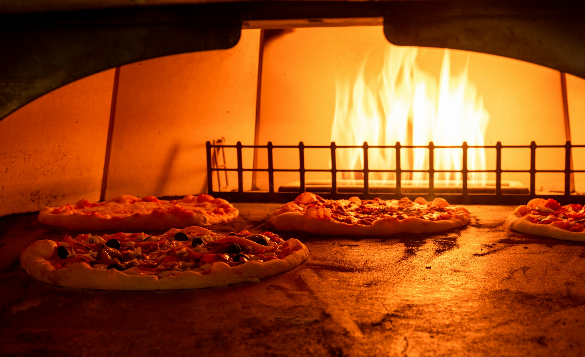 Pizzas baking in a wood-fired oven