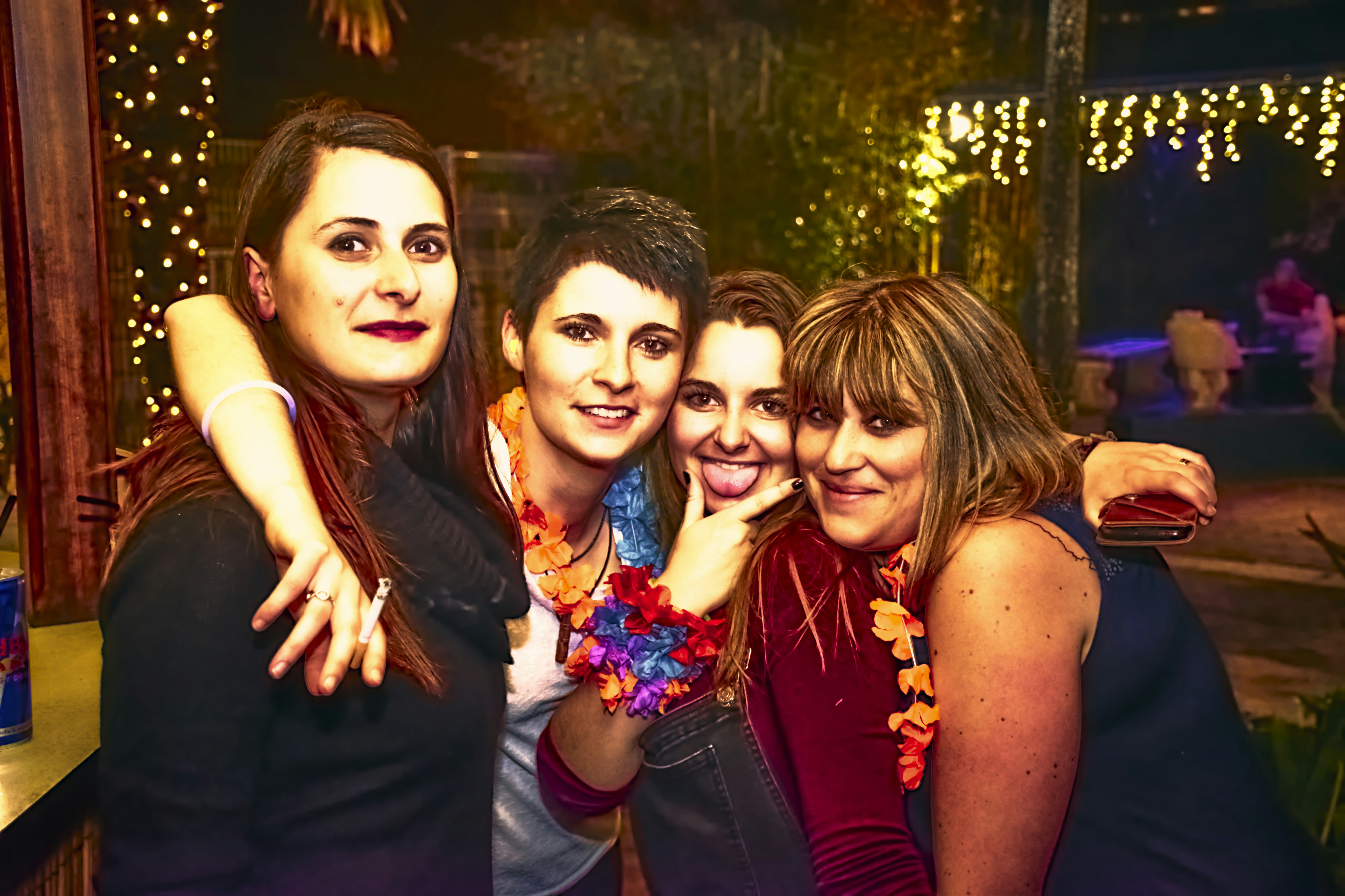 Four friends posing together at a festive gathering