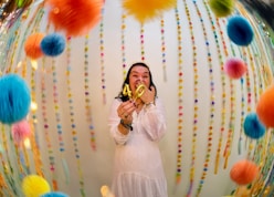Woman celebrating with "40" balloons and colorful decorations