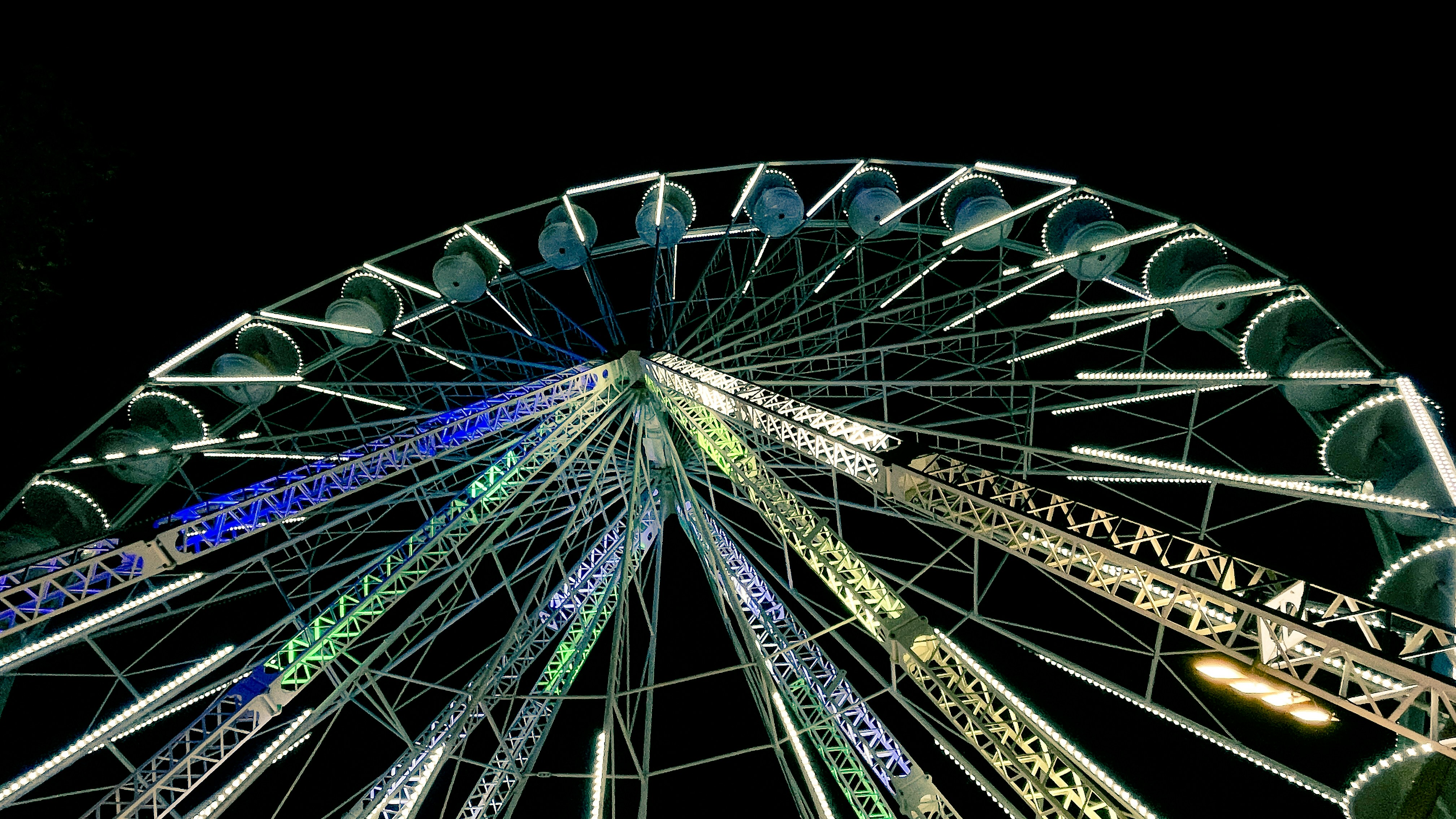 A brightly lit ferris wheel at night