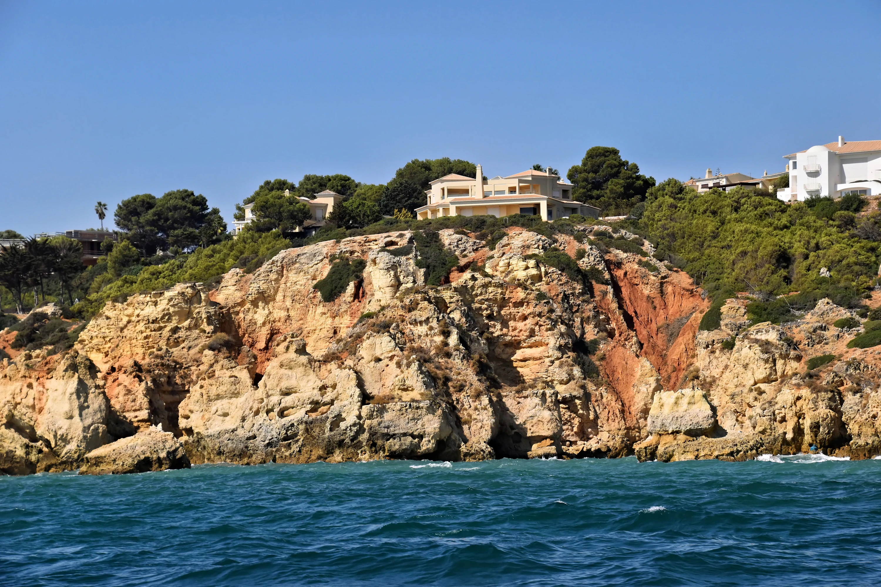 Serene Mediterranean coastal architectural villa overlooking tranquil turquoise waters