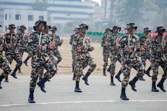 Soldiers in camouflage uniforms marching in formation.
