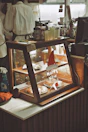 Dessert display case with pies and holiday decorations.