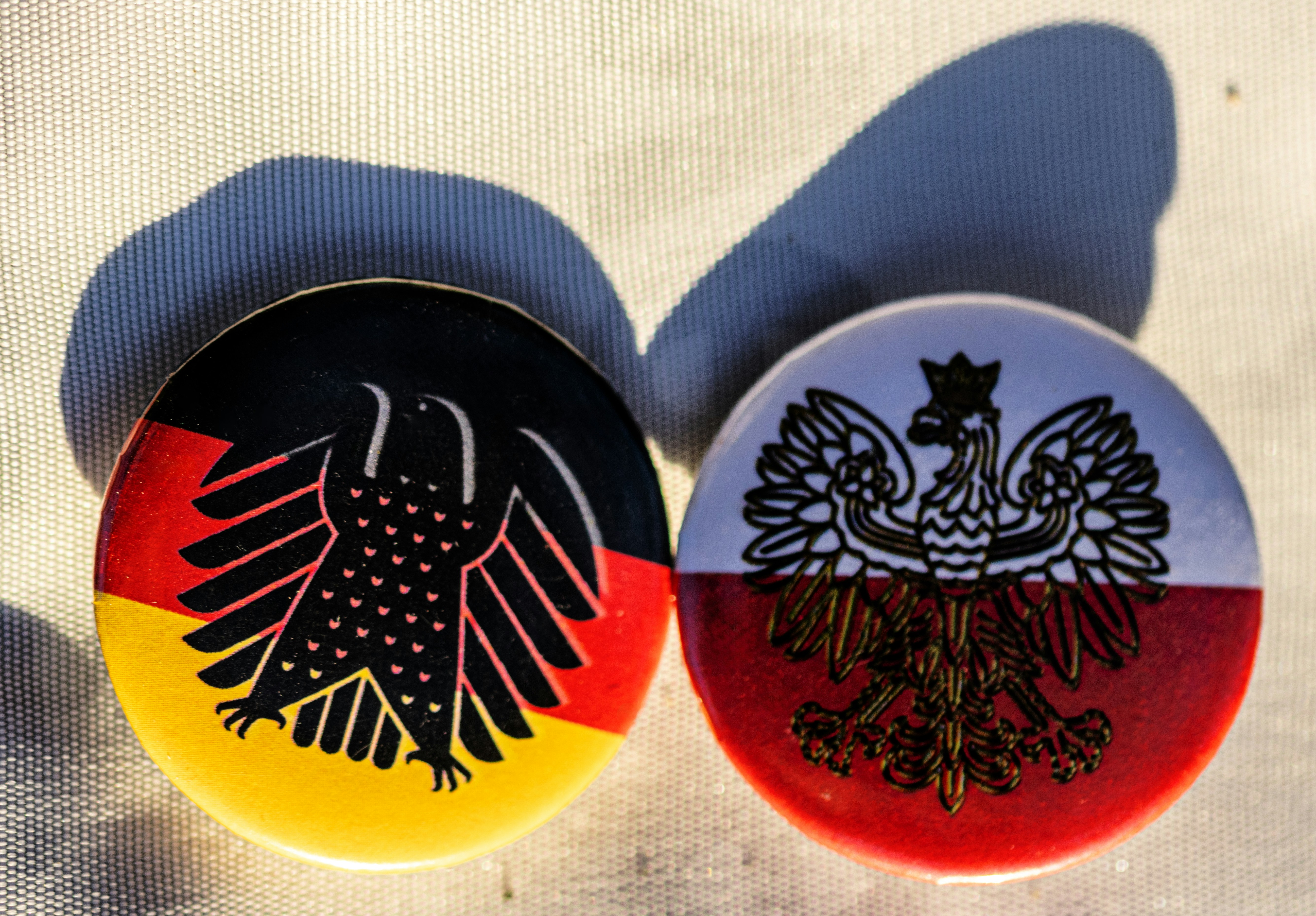German and polish flag pins side by side