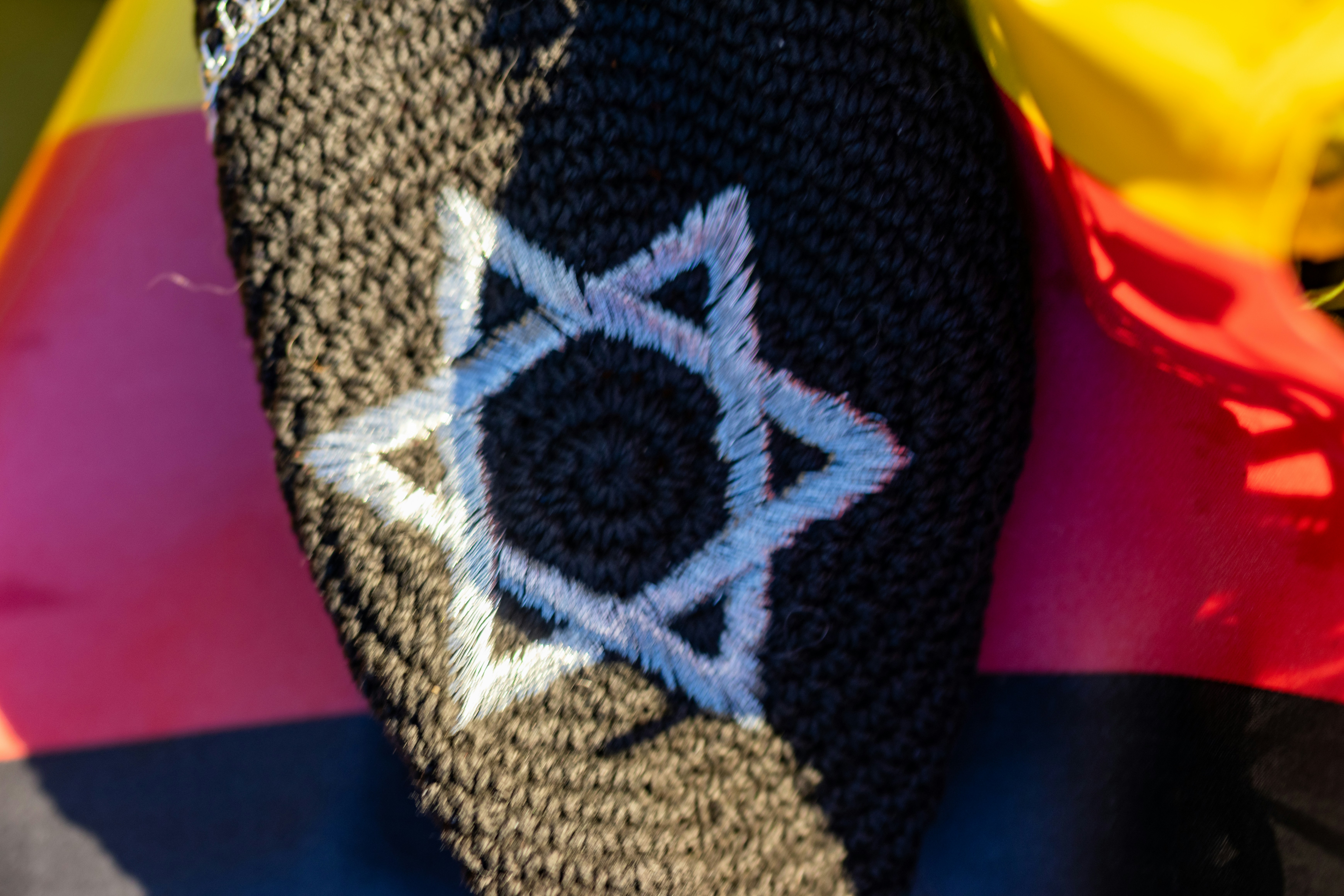 A star of david embroidered on black fabric.