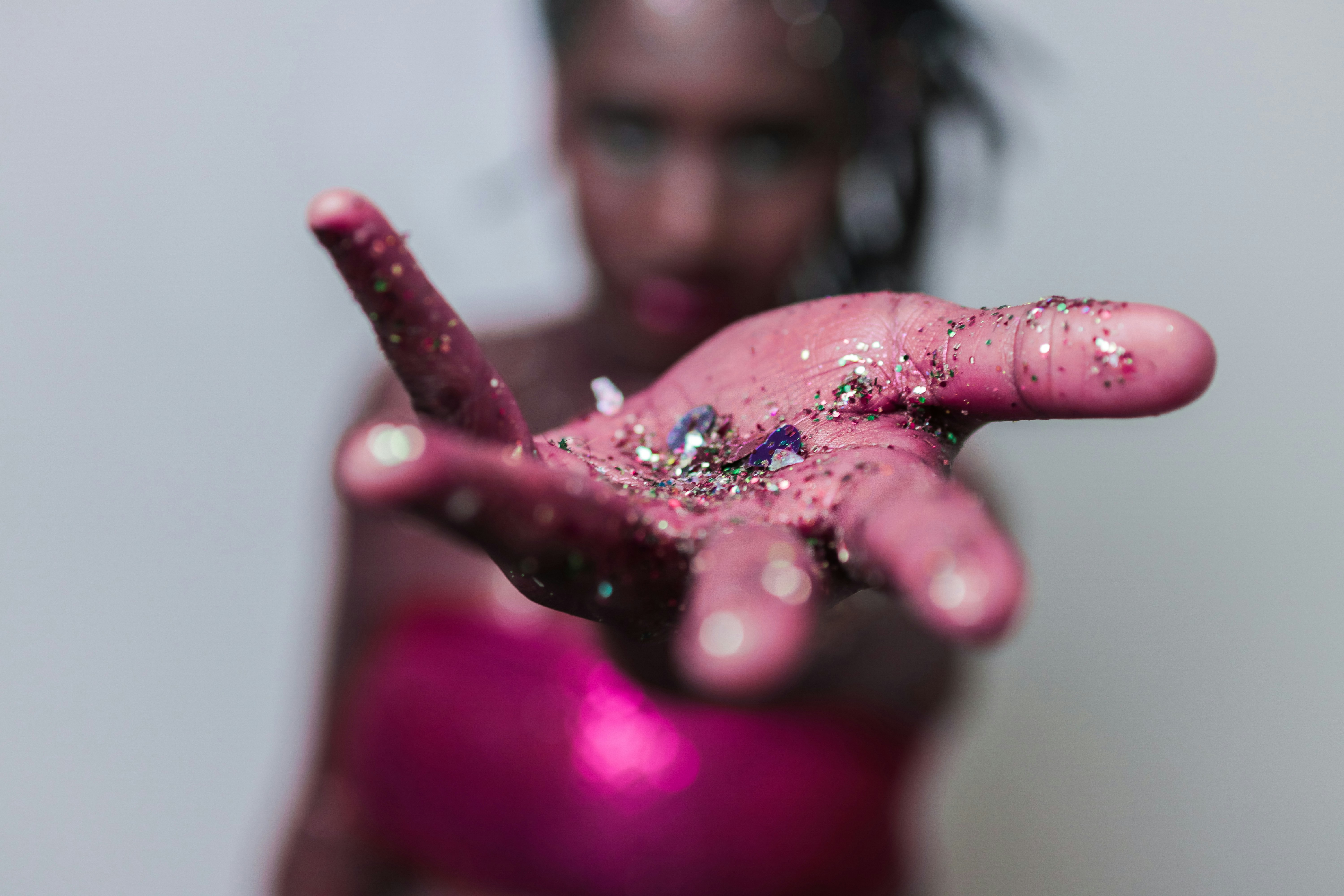 Woman's hand covered in glitter